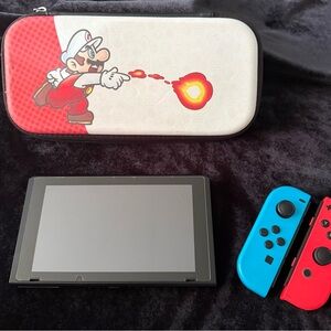 Nintendo Switch with Red and Blue Controllers and Mario Case